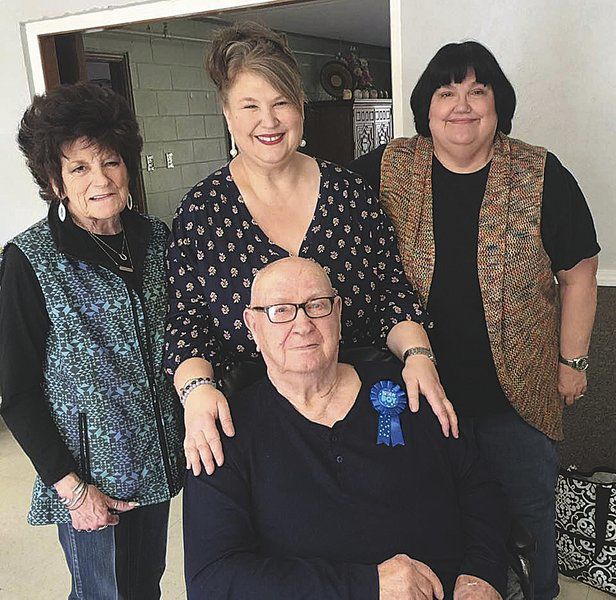 Three sisters show love for their father through plate glass window at nursing home